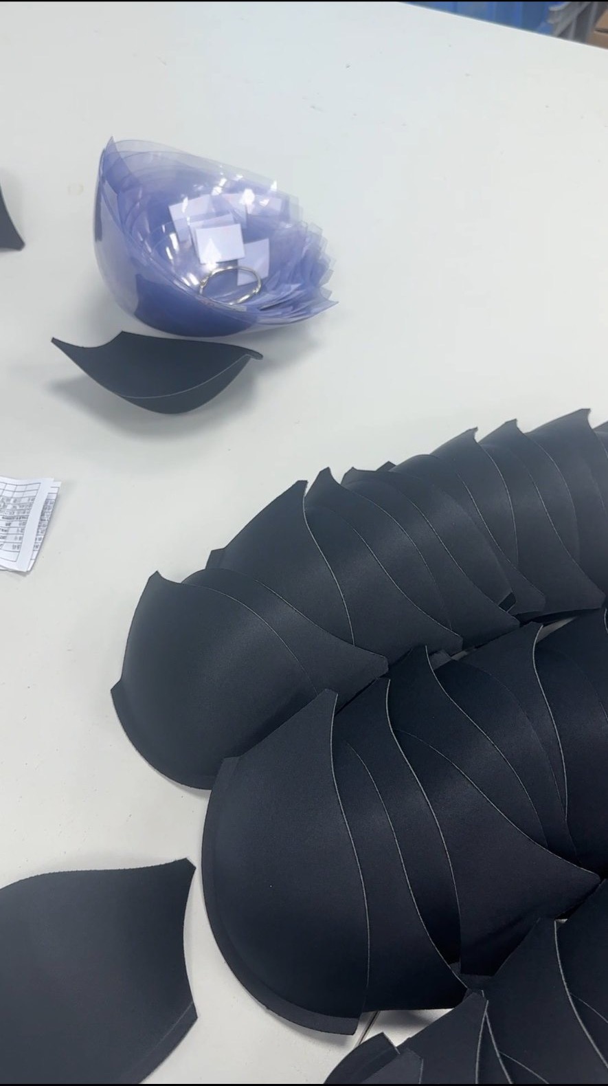 Moulded bra cups laid out on a table for a size check at the Alvira Lingerie workshop in Dongguan